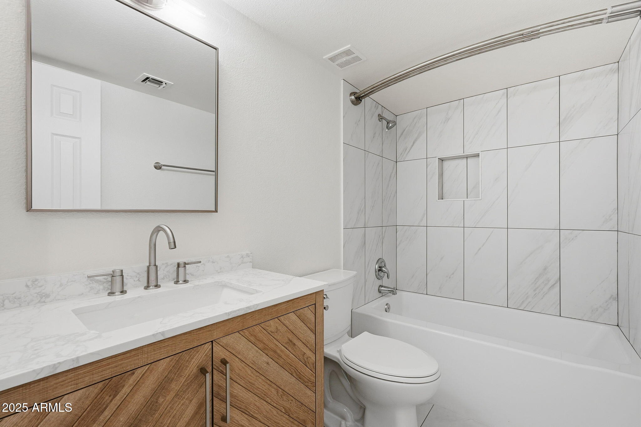 4201 East Camelback Road, Unit 74 Phoenix, AZ 85018 - Photo 16 of 20 a bathroom with a sink a toilet and shower