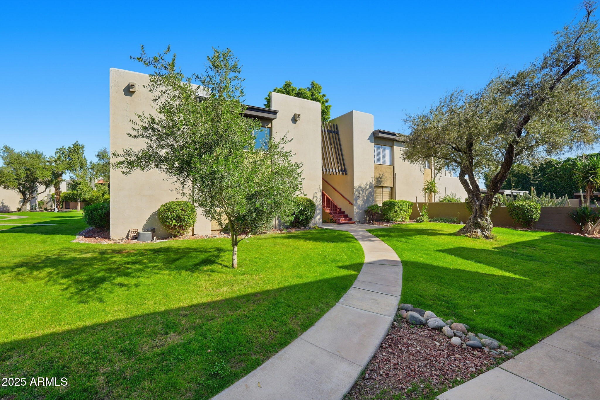 4201 East Camelback Road, Unit 74 Phoenix, AZ 85018 - Photo 20 of 20 a front view of a house with a yard