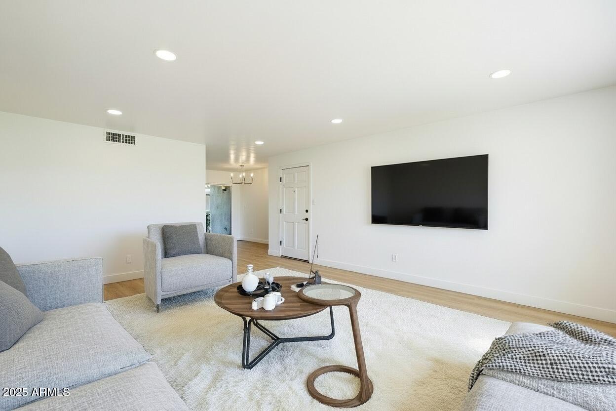 4201 East Camelback Road, Unit 74 Phoenix, AZ 85018 - Photo 8 of 20 a living room with furniture and a flat screen tv