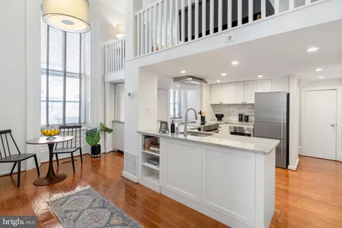 a living room with furniture potted plant and a window