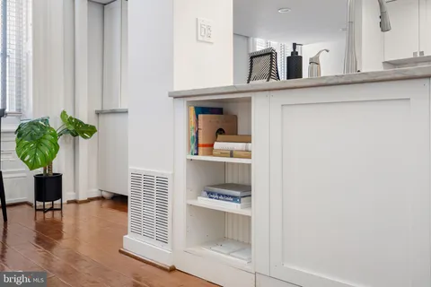 a living room with furniture a fireplace and large windows
