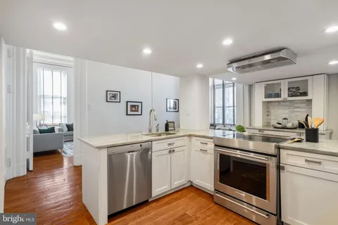 a living room with furniture a rug and a fireplace
