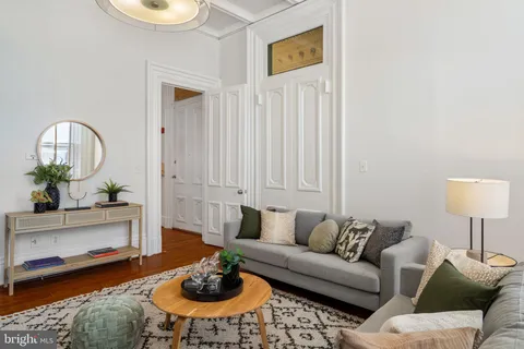a large bed sitting in a bedroom next to a window