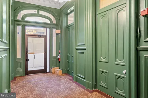 a kitchen with stainless steel appliances kitchen island granite countertop a stove a sink a refrigerator and chairs