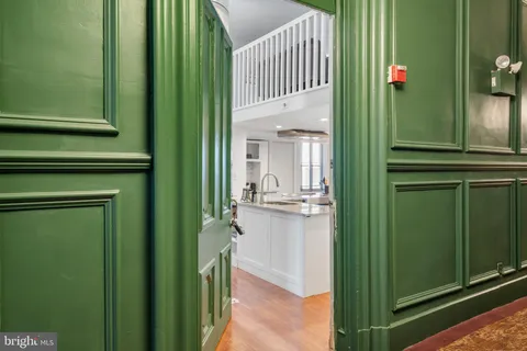 a kitchen with cabinets stainless steel appliances and sink