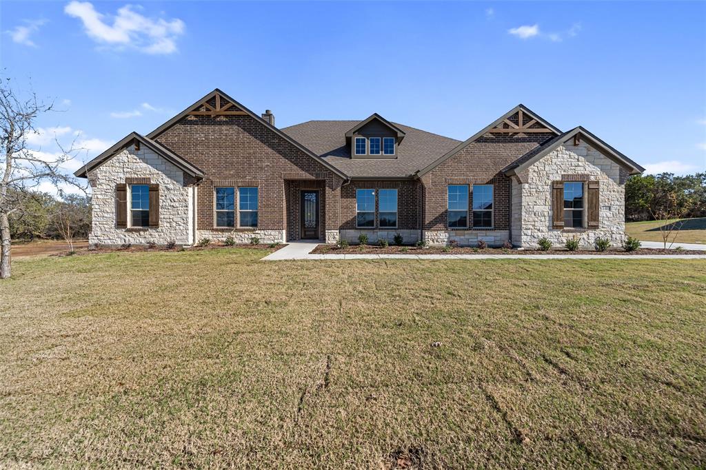 140 Oak Grv Way Springtown, TX 76082 - Photo 2 of 40 a front view of a house with yard