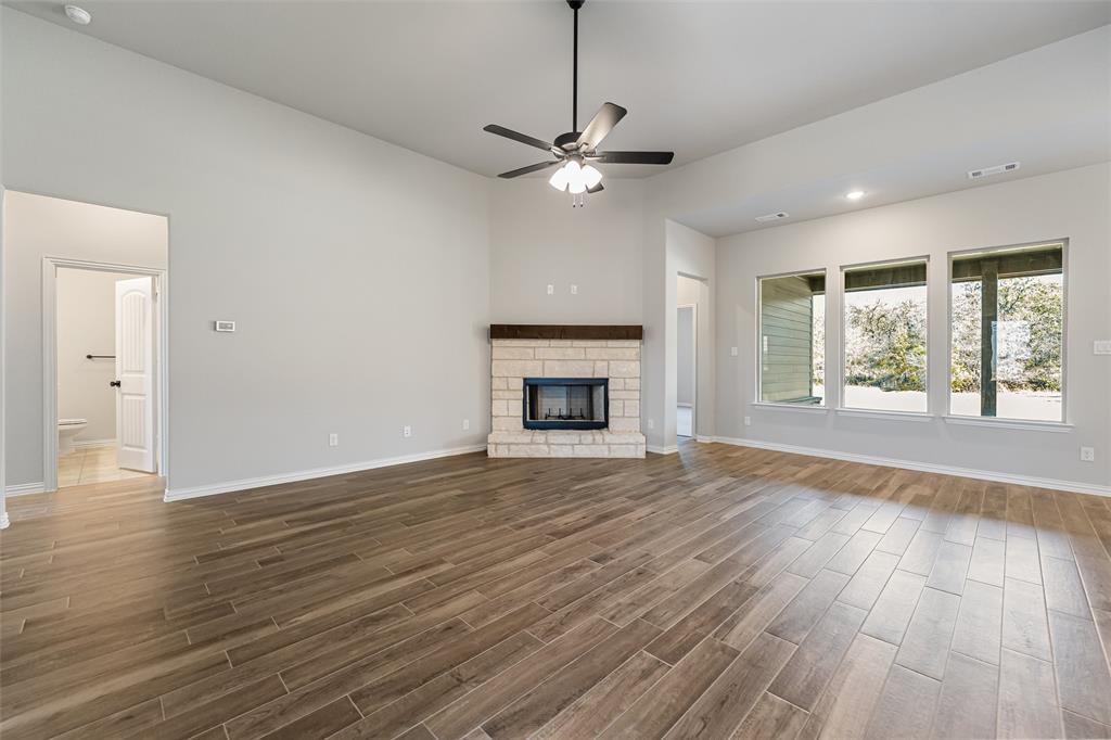 140 Oak Grv Way Springtown, TX 76082 - Photo 21 of 40 a view of an empty room with wooden floor and a window