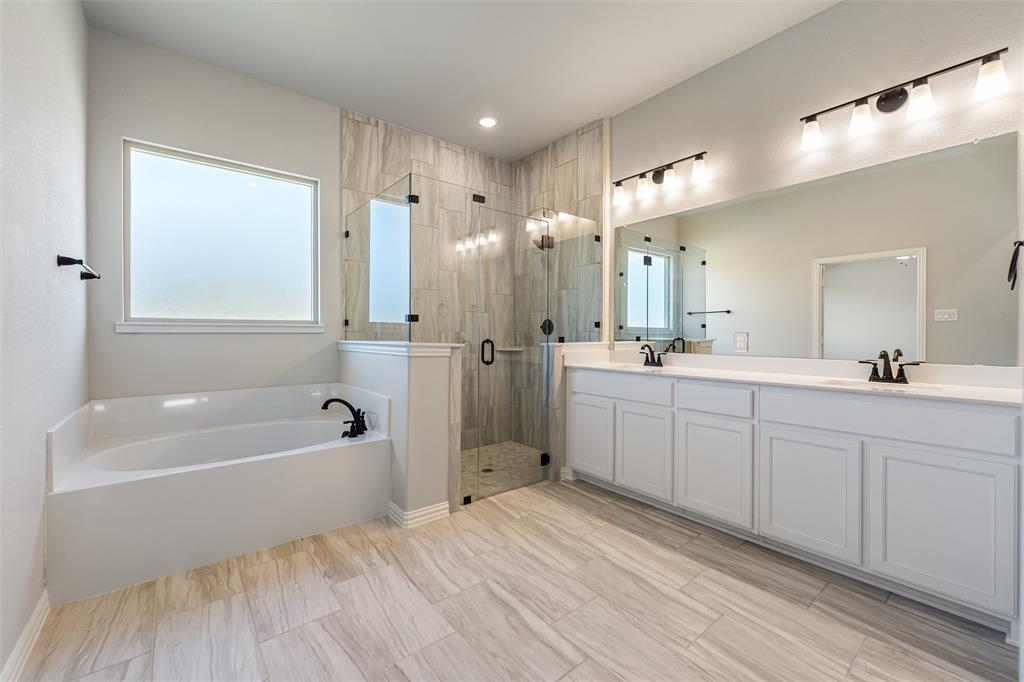140 Oak Grv Way Springtown, TX 76082 - Photo 31 of 40 a spacious bathroom with a tub sink shower and mirror