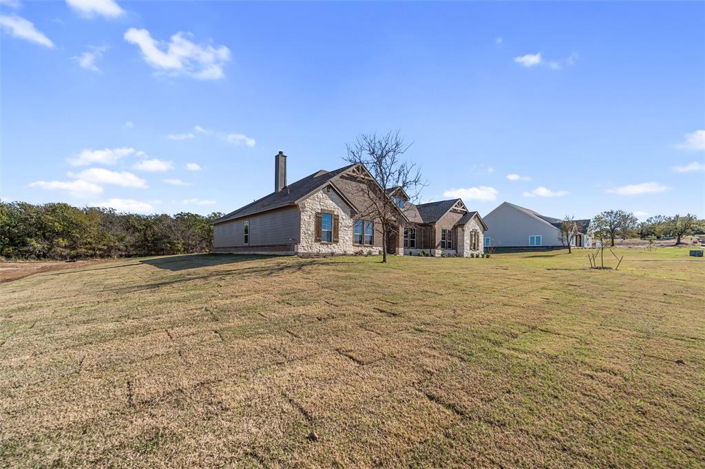 140 Oak Grv Way Springtown, TX 76082 - Photo 4 of 40 a bathroom with a sink and a yard