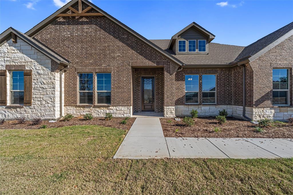 140 Oak Grv Way Springtown, TX 76082 - Photo 7 of 40 a front view of a house with garden