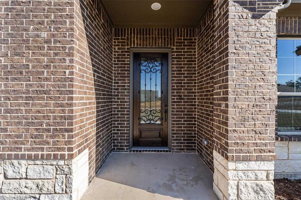 140 Oak Grv Way Springtown, TX 76082 - Photo 8 of 40 a front view of a house with a door