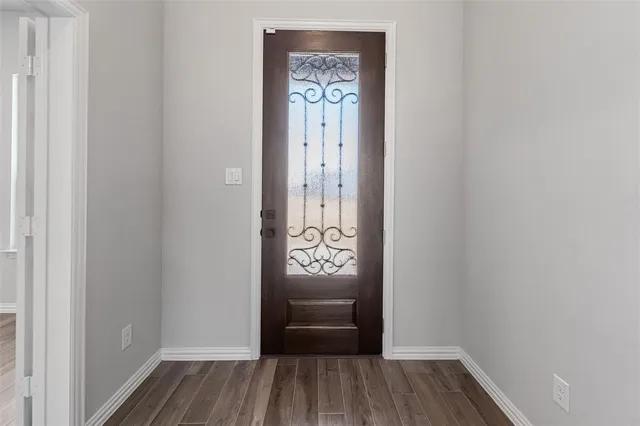 a view of an entryway with wooden floor