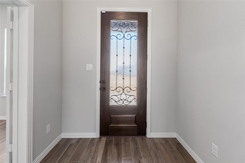 140 Oak Grv Way Springtown, TX 76082 - Photo 9 of 40 a view of an entryway with wooden floor