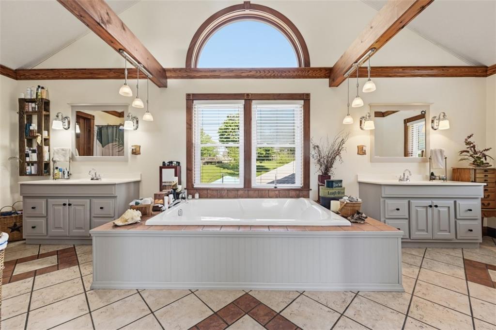 2976 Henderson Road Washington, PA 15301 - Photo 27 of 50 a bathroom with a tub a double vanity sink a window and mirror