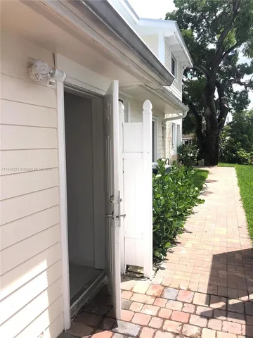 a view of a hallway with wooden floor and furniture