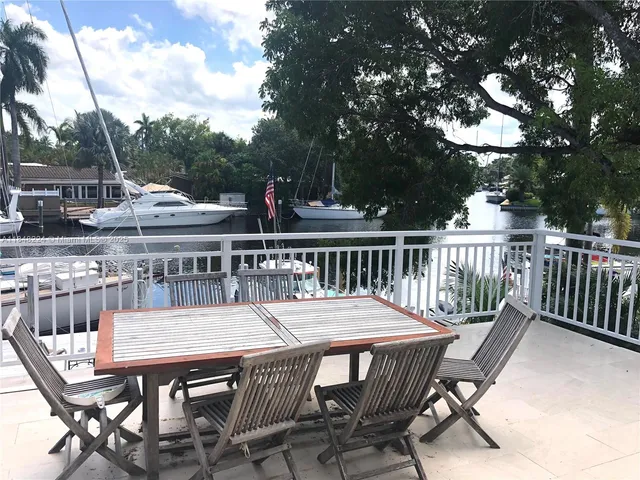 a balcony with table and chairs
