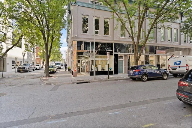 a view of a street that has couple of cars parked on the road