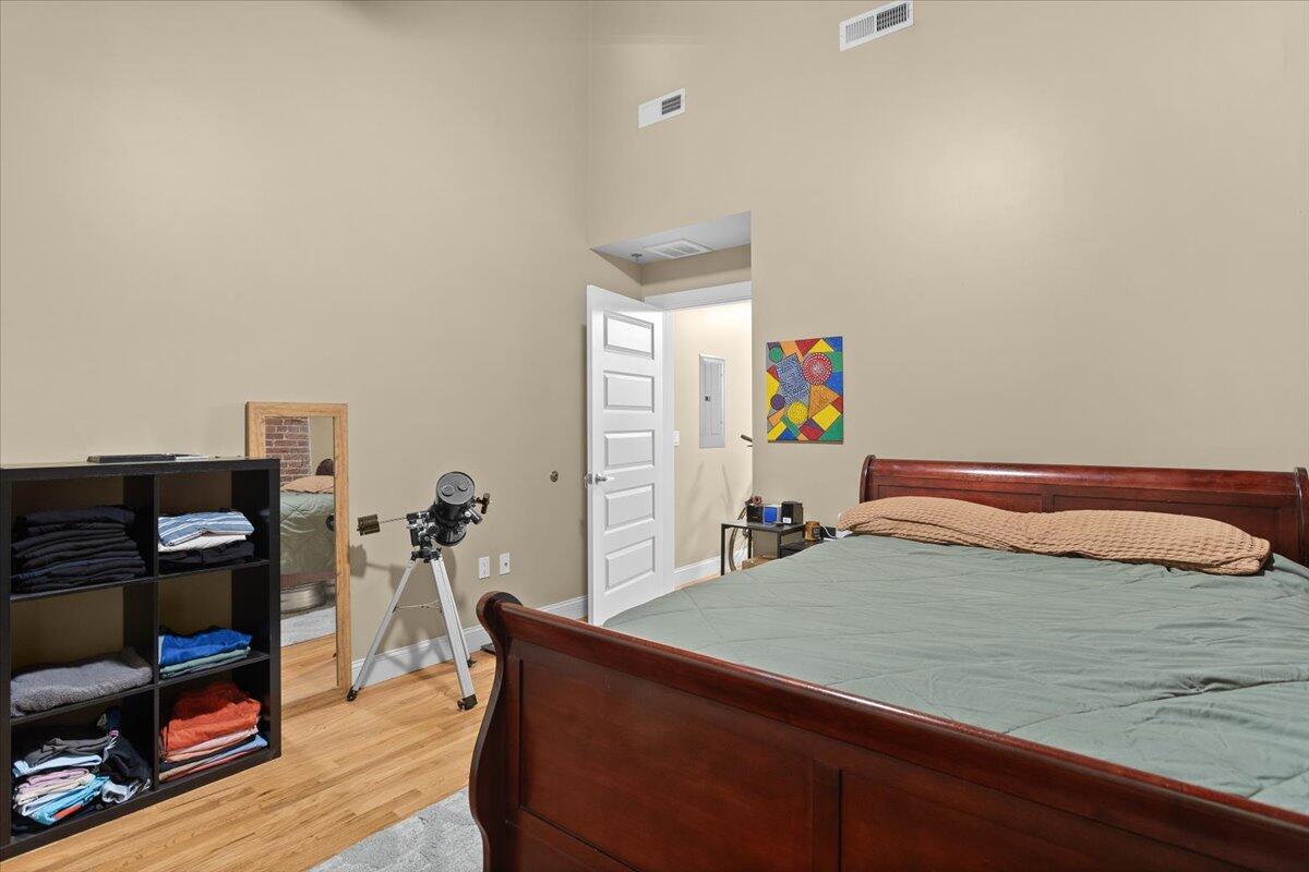 302 1st Street Southwest Roanoke, VA 24011 - Photo 103 of 110 a bedroom with a bed and a flat tv screen on a dresser
