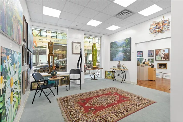 a living room with fireplace furniture and a potted plant