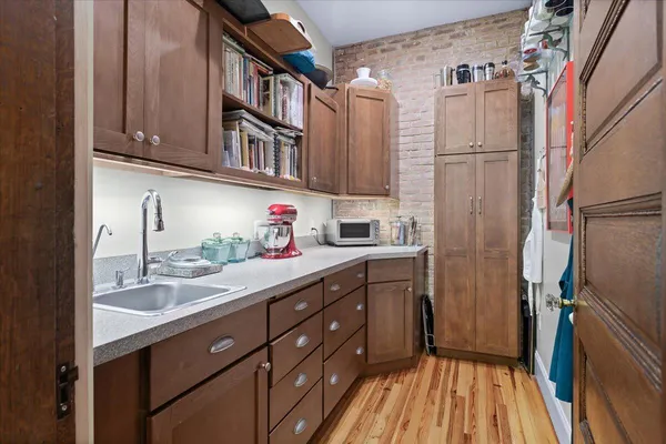 a kitchen with stainless steel appliances granite countertop a sink a stove and cabinets