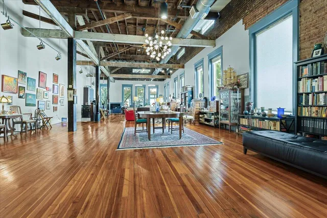 a dining room with furniture a rug and wooden floor