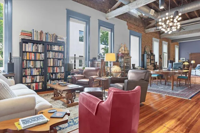 a bedroom with a bed and dresser with mirror