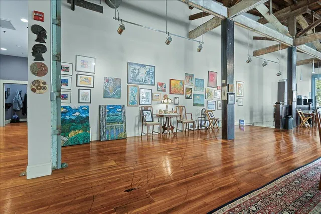 a kitchen with stainless steel appliances granite countertop a refrigerator a stove and a wooden floors