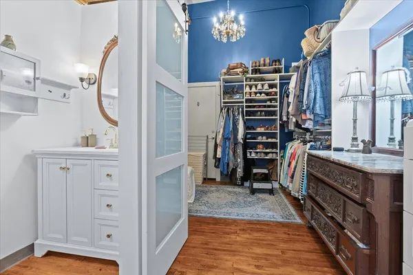 a bathroom with a granite countertop sink a mirror and a shower