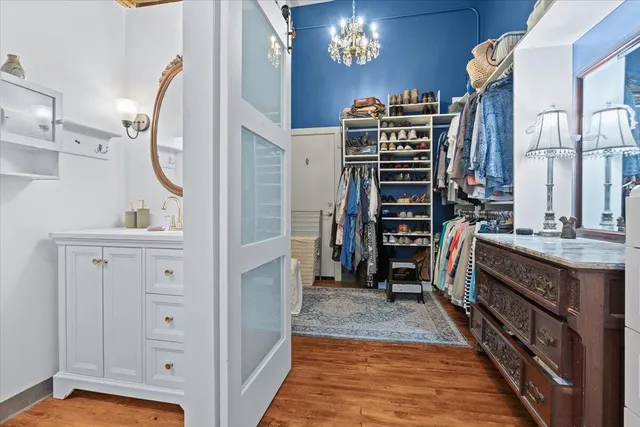 a bathroom with a granite countertop sink a mirror and a shower