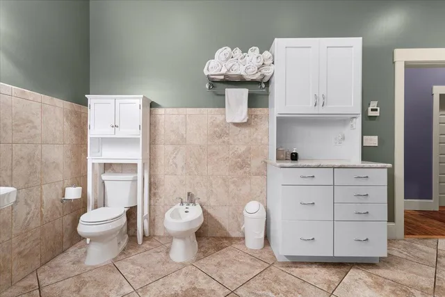 a view of a hallway with wooden floor and entryway