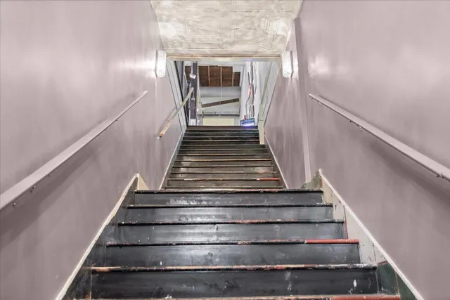 a bedroom with a bed and a flat tv screen on a dresser