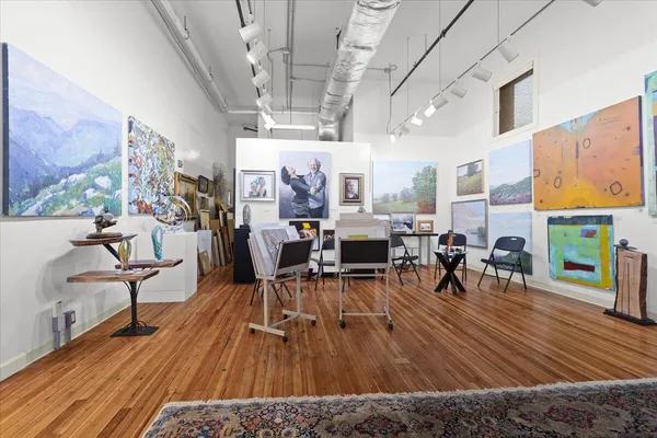 a kitchen with stainless steel appliances kitchen island granite countertop a refrigerator a stove and a sink with granite countertops