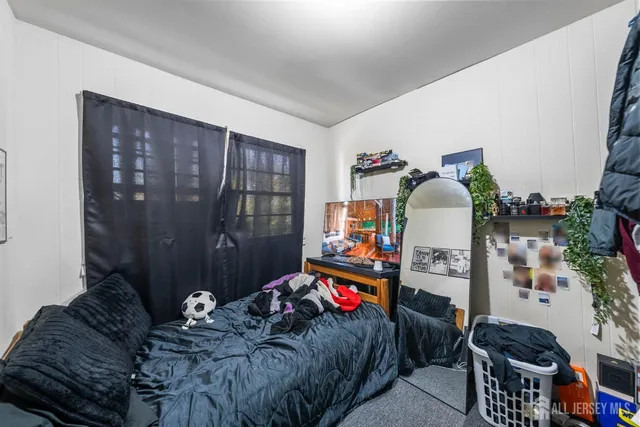 a bedroom with bed and a window