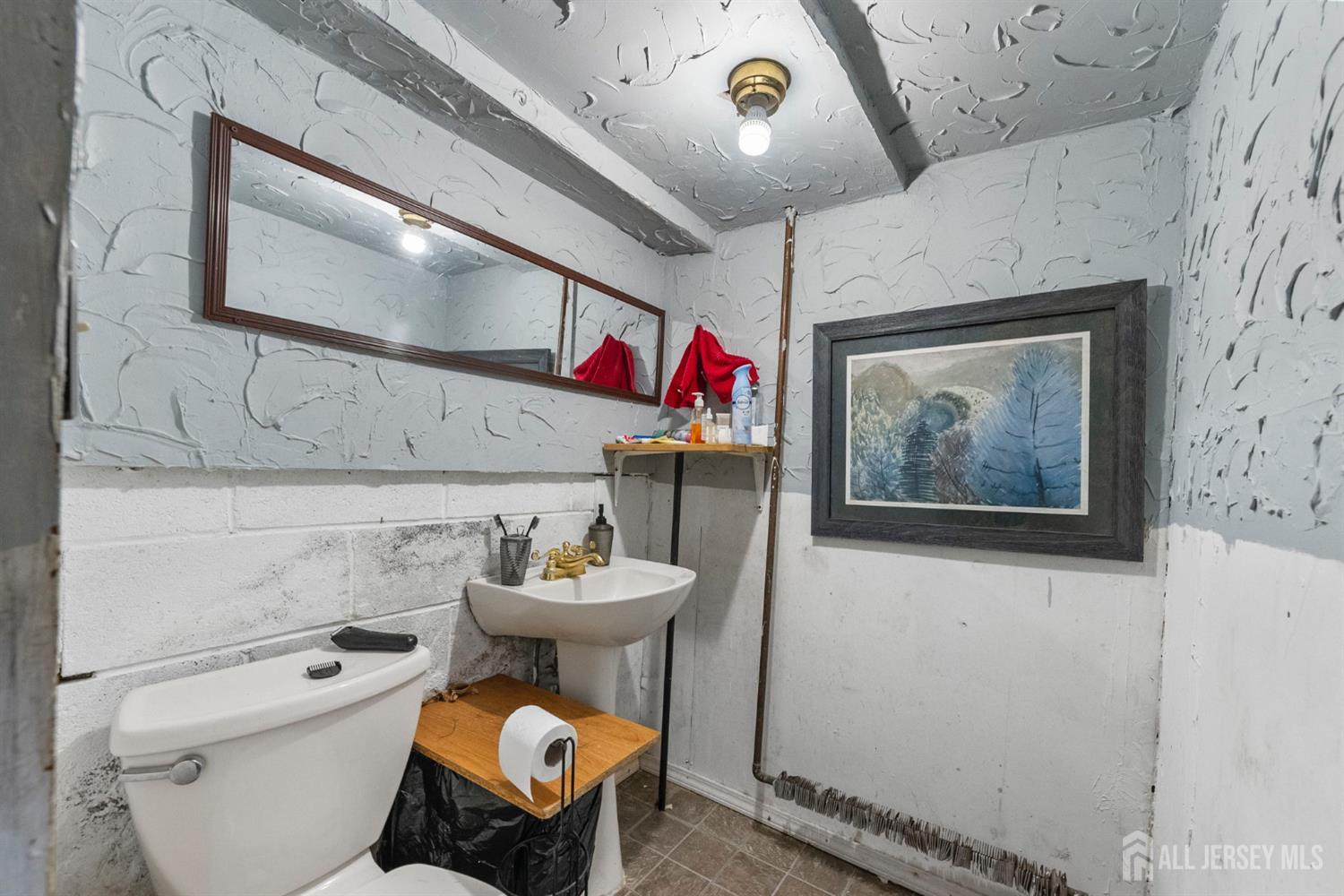 55 Frank Street Somerset, NJ 08873 - Photo 16 of 33 a bathroom with a toilet sink and mirror