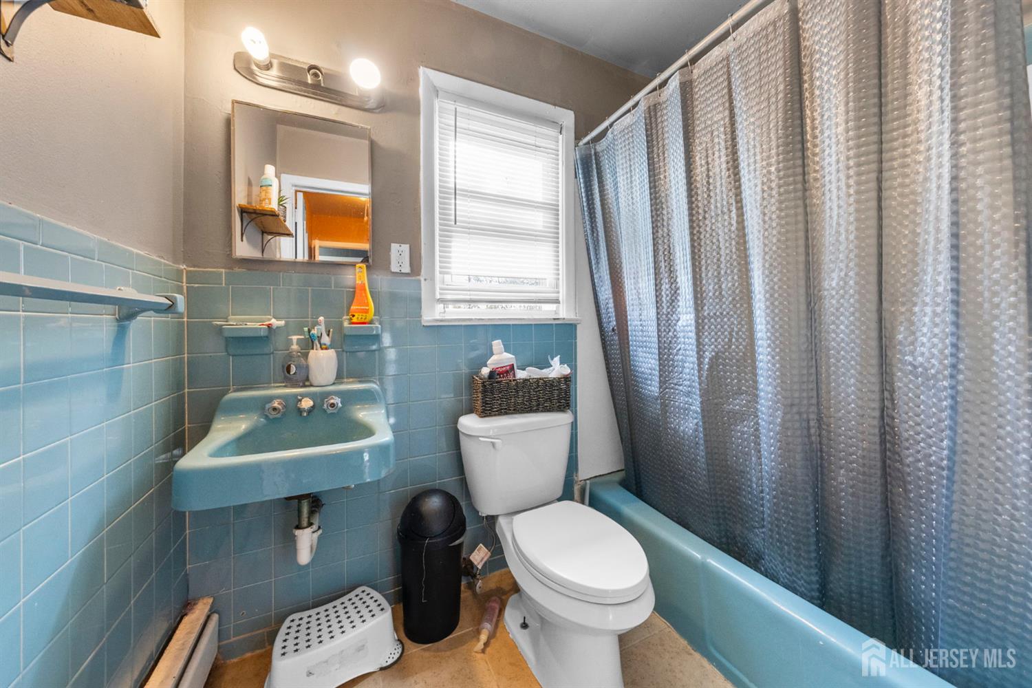 55 Frank Street Somerset, NJ 08873 - Photo 26 of 33 a bathroom with a toilet a sink and mirror