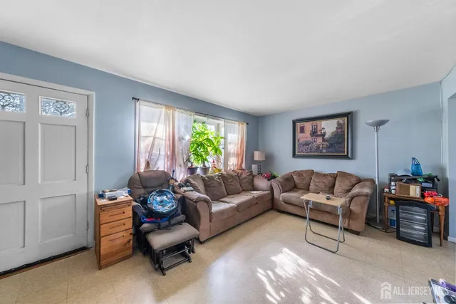 a dining room with furniture a rug and a large window