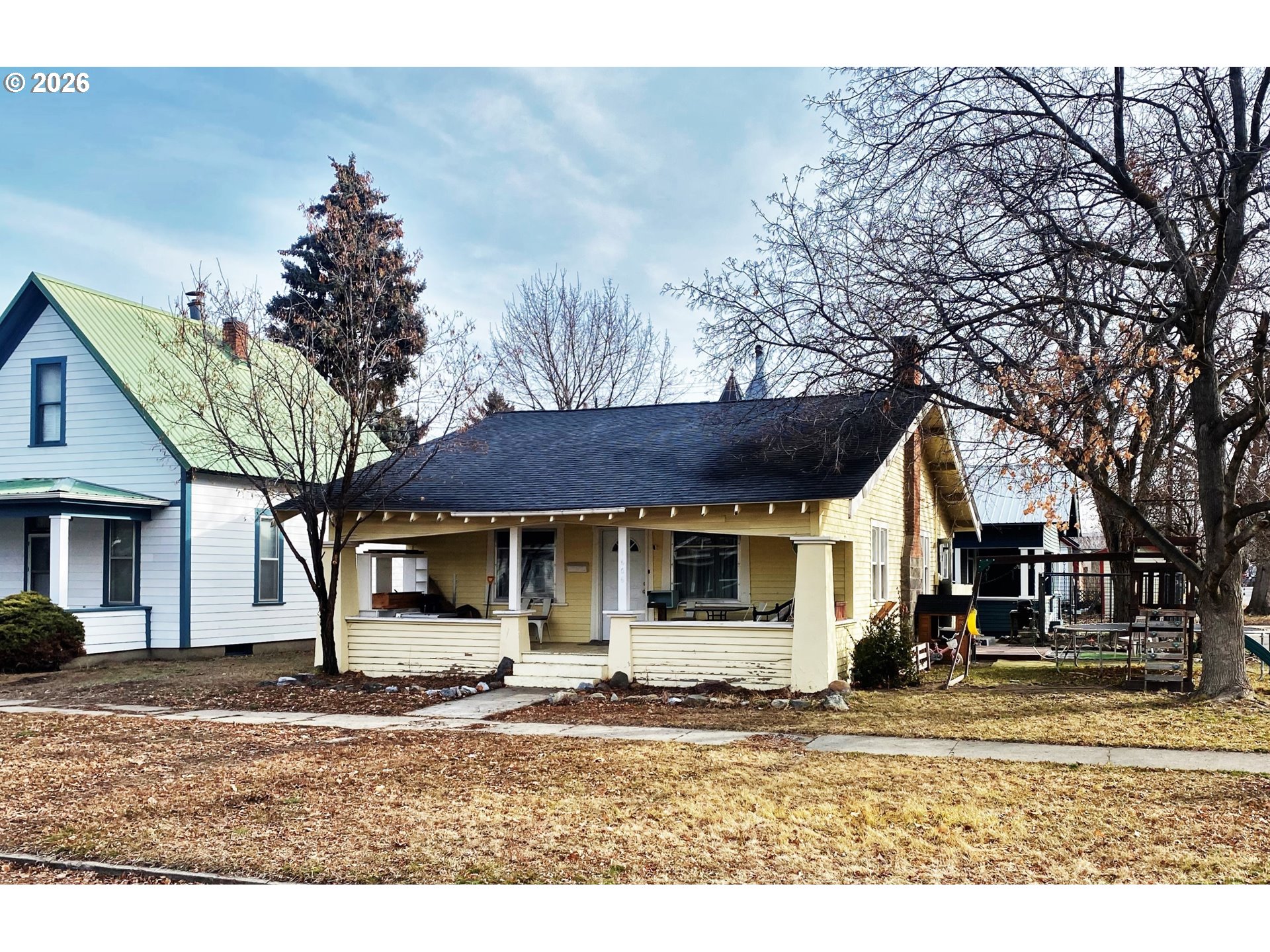 a house that has a tree in front of it