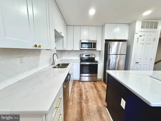 a kitchen with a table chairs refrigerator and window