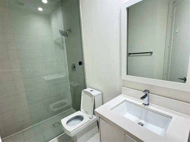 a bathroom with a sink toilet and shower