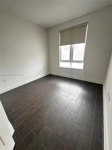 an empty room with wooden floor