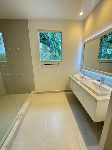 a bathroom with a sink toilet and window
