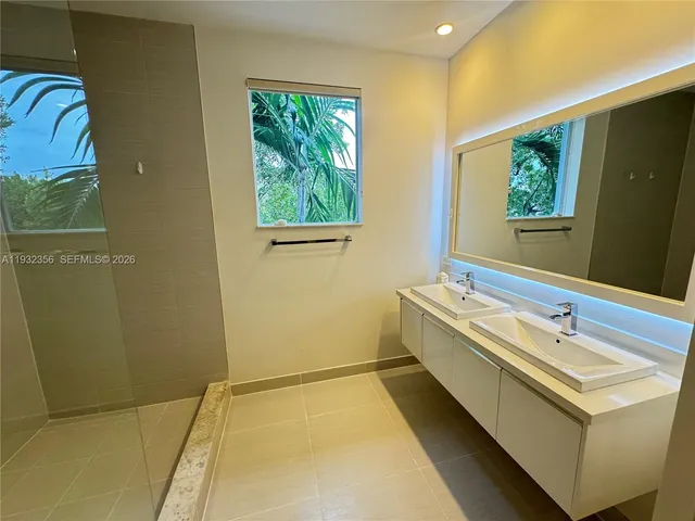a bathroom with a sink and a large mirror