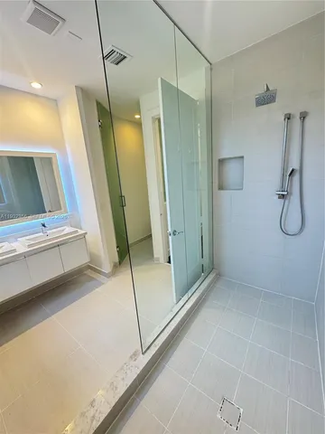 a bathroom with a shower and a mirror