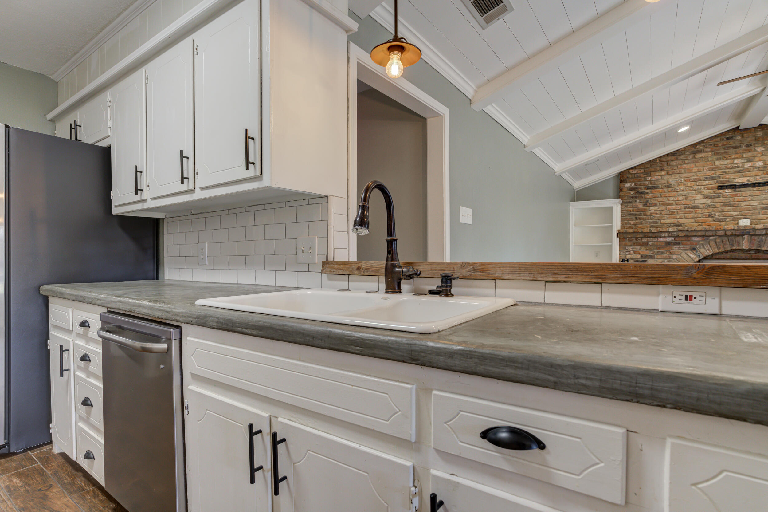 7106 Zoar Avenue Lubbock, TX 79424 - Photo 14 of 33 a sink with granite countertop white cabinets and a sink