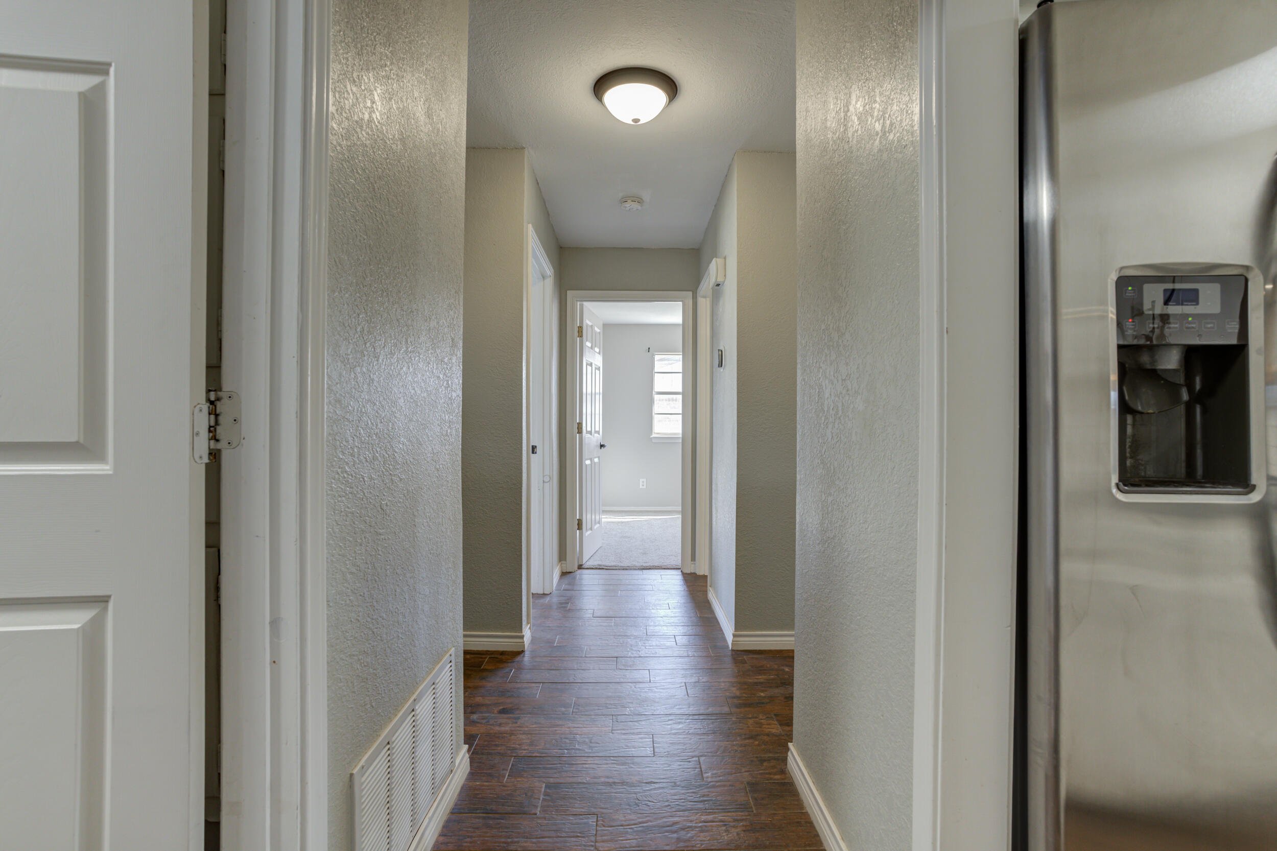 7106 Zoar Avenue Lubbock, TX 79424 - Photo 17 of 33 a view of a hallway with wooden floor