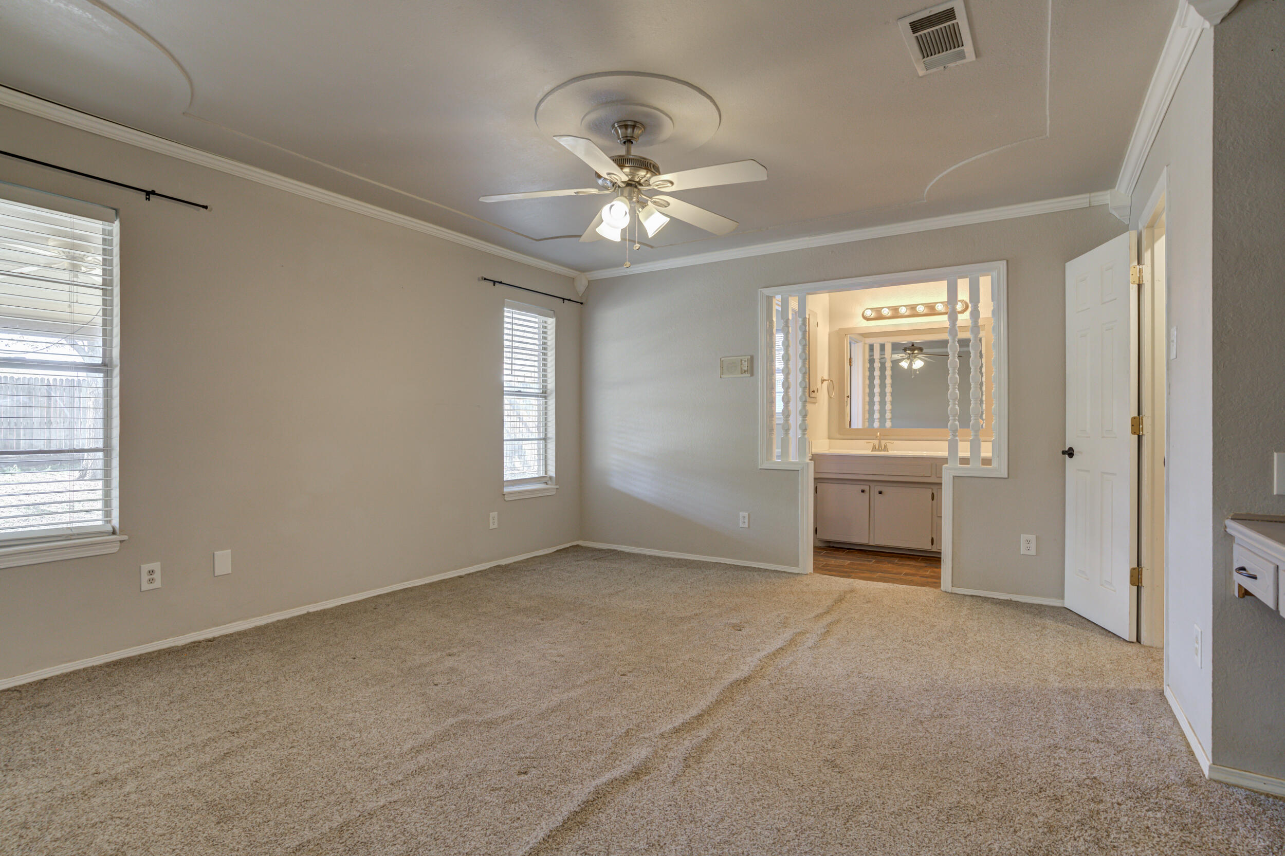 7106 Zoar Avenue Lubbock, TX 79424 - Photo 18 of 33 a view of a livingroom with a ceiling fan and window