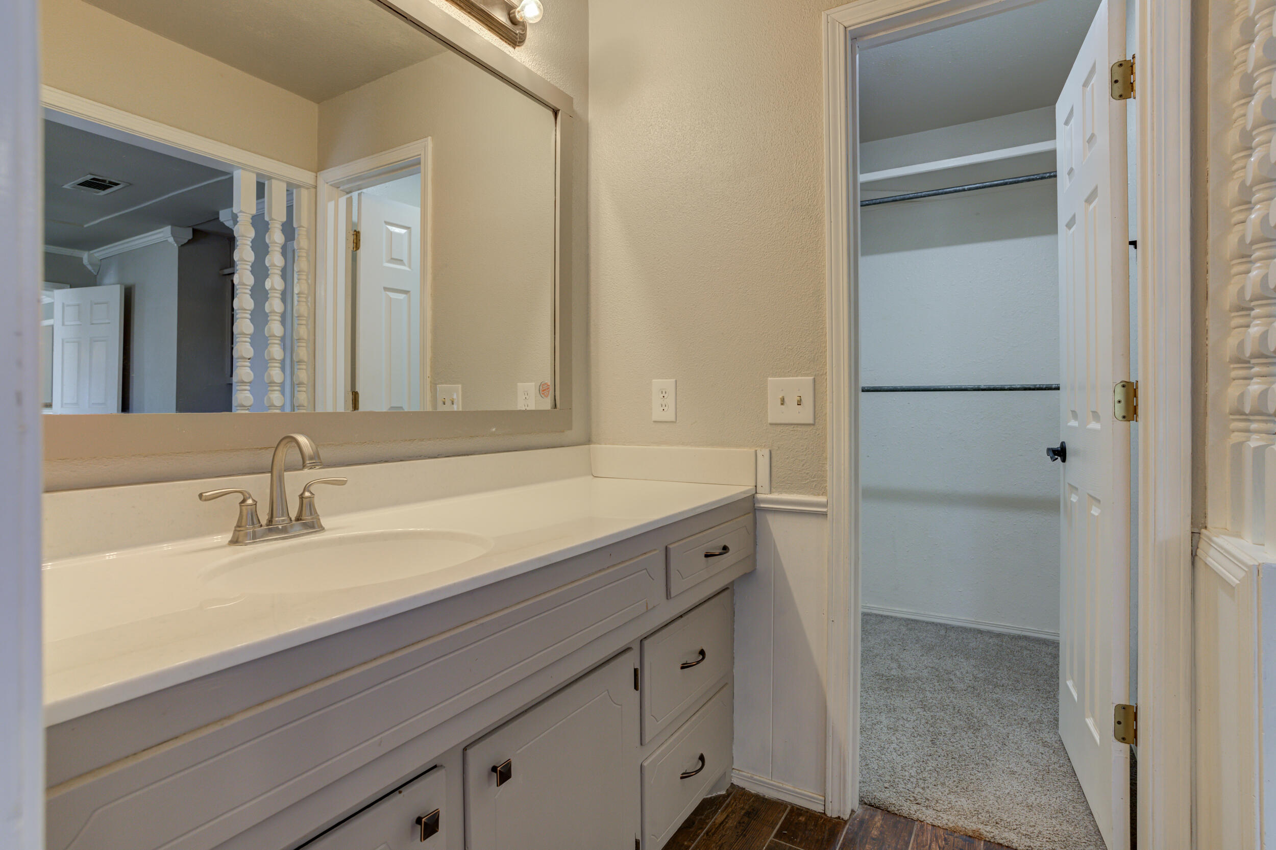 7106 Zoar Avenue Lubbock, TX 79424 - Photo 22 of 33 a bathroom with a sink and a mirror