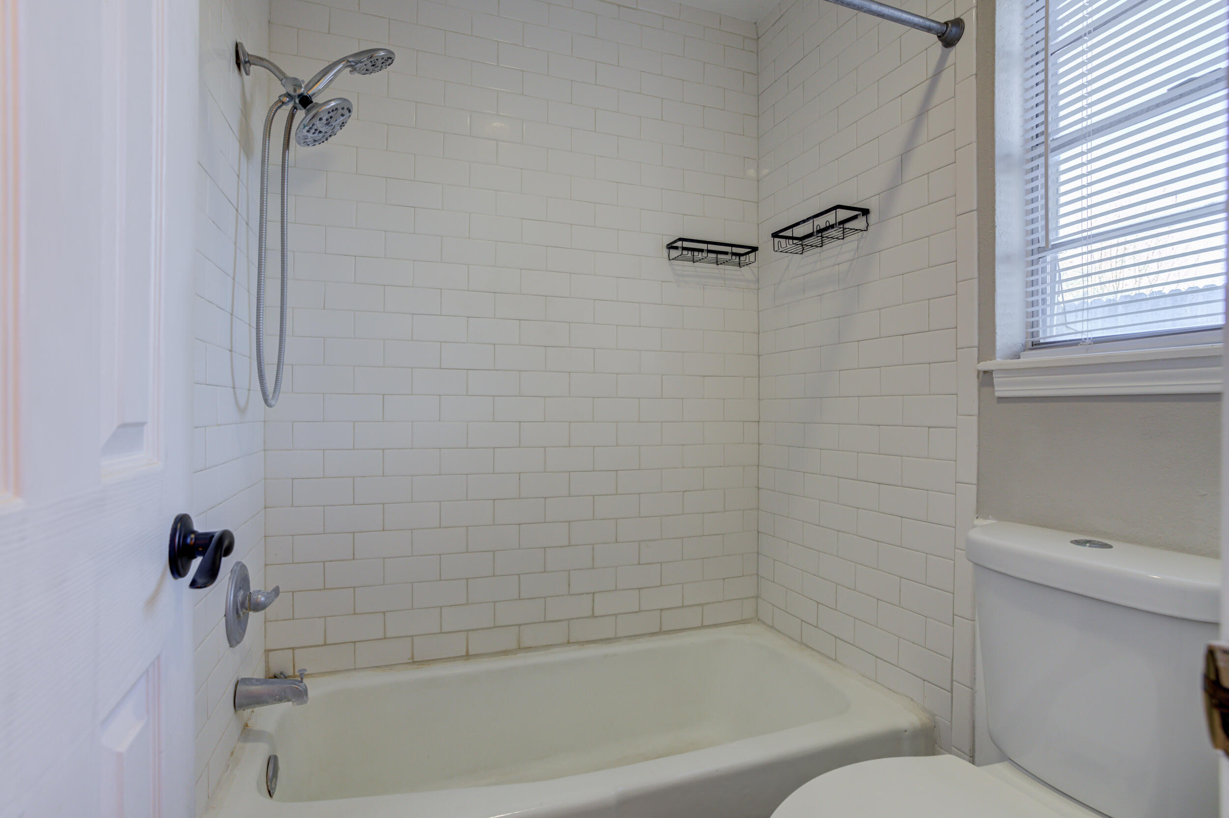 7106 Zoar Avenue Lubbock, TX 79424 - Photo 23 of 33 a bathroom with a shower and a toilet