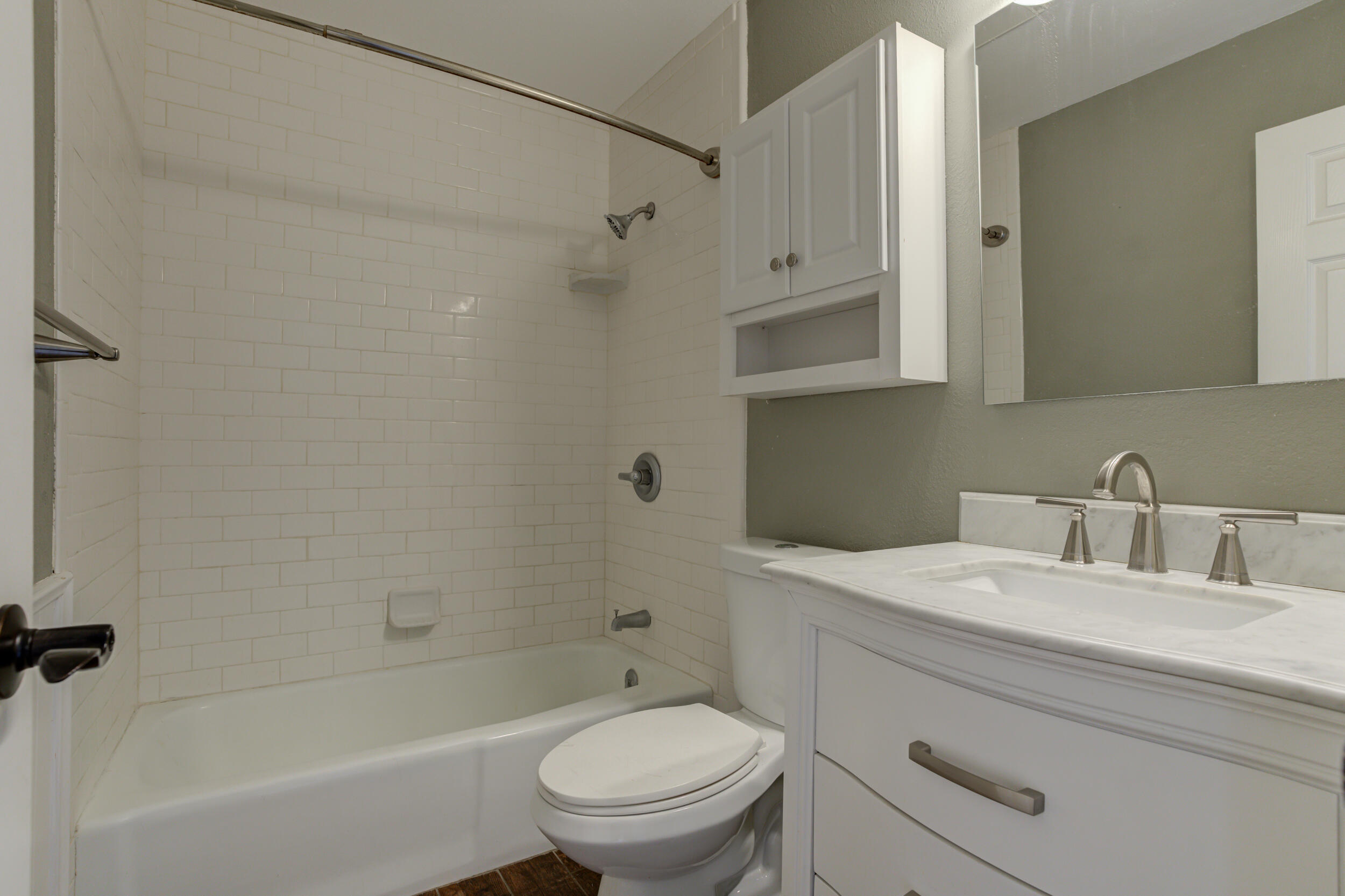 7106 Zoar Avenue Lubbock, TX 79424 - Photo 26 of 33 a bathroom with a granite countertop toilet a sink and bathtub