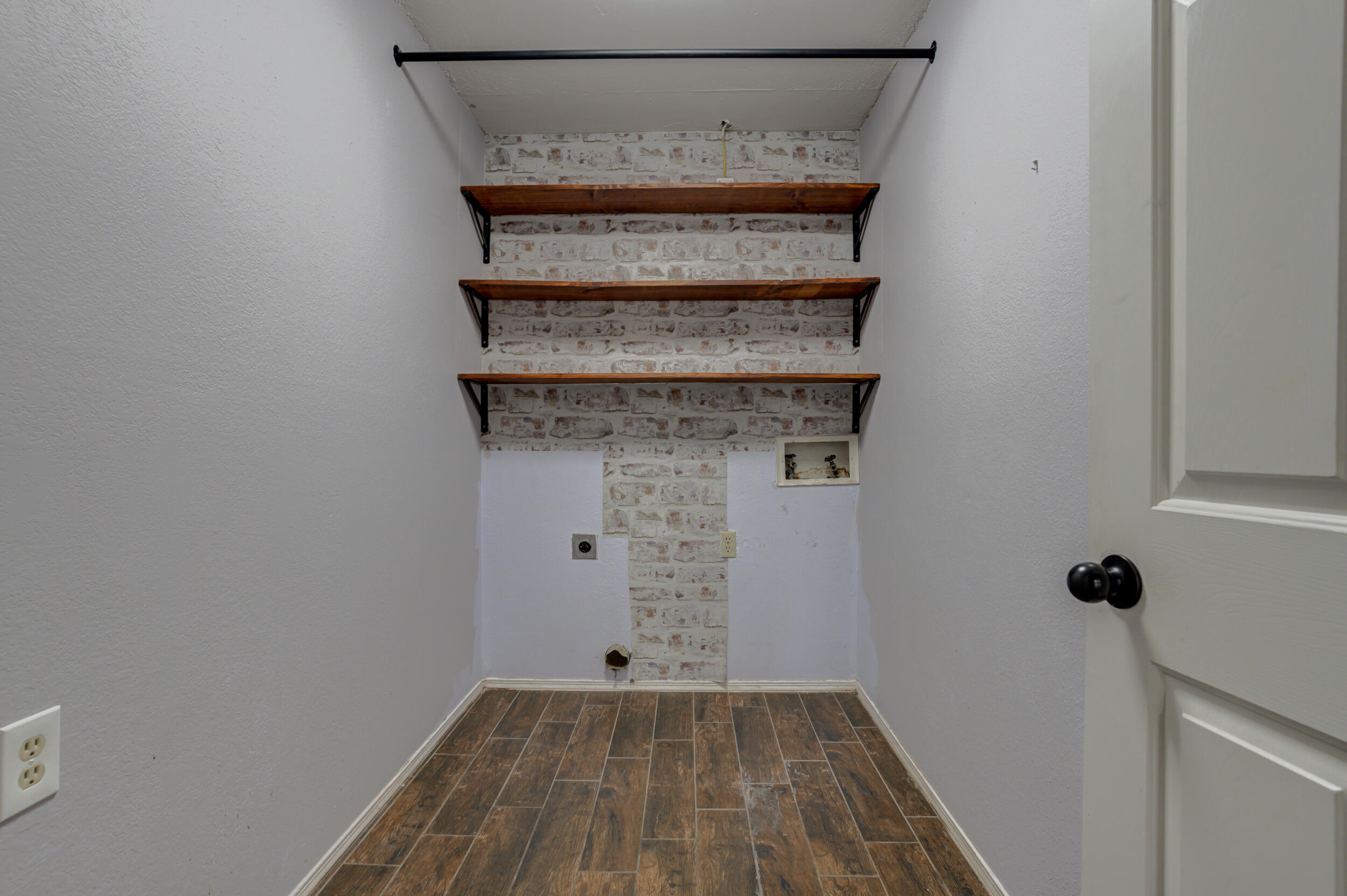 7106 Zoar Avenue Lubbock, TX 79424 - Photo 27 of 33 a room with a door and wooden floor